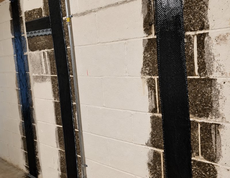 Carbon fiber straps installed on a block foundation wall